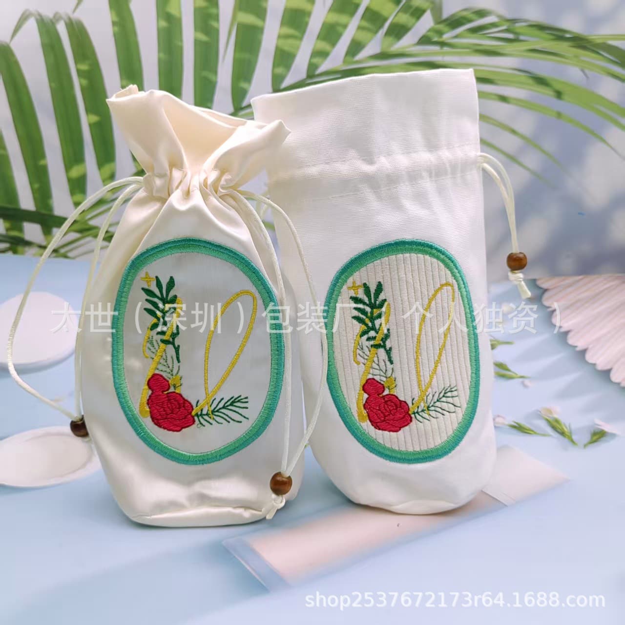 Factory-customized round-bottom embroidered drawstring bags in canvas or silk, available in multiple colors and custom embroidery designs for wedding candy packaging.