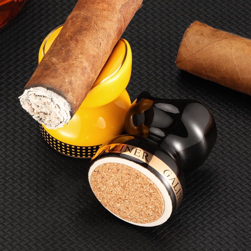 Portable ceramic cigar holder with large-diameter smoke tray. Also includes accessories for cigar smoking.