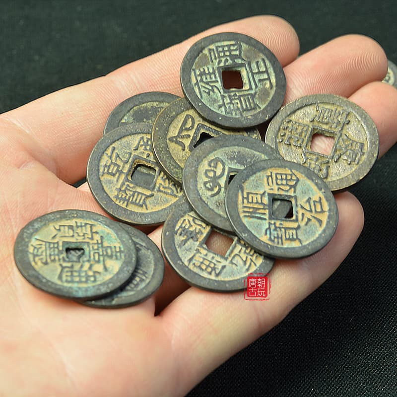 Antique-style copper coins with square holes, Qing Dynasty Five Emperors coins, green patina, and random characters on the reverse.