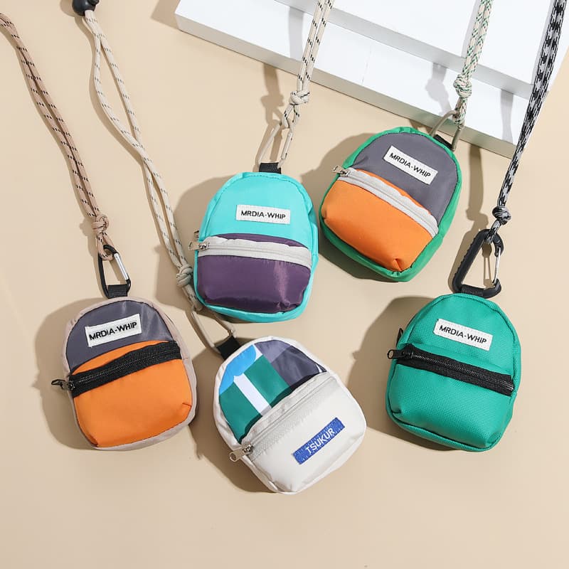 Trendy color-block backpack, coin purse, mini keychain, portable for men and women, perfect for storing headphones and ID cards.