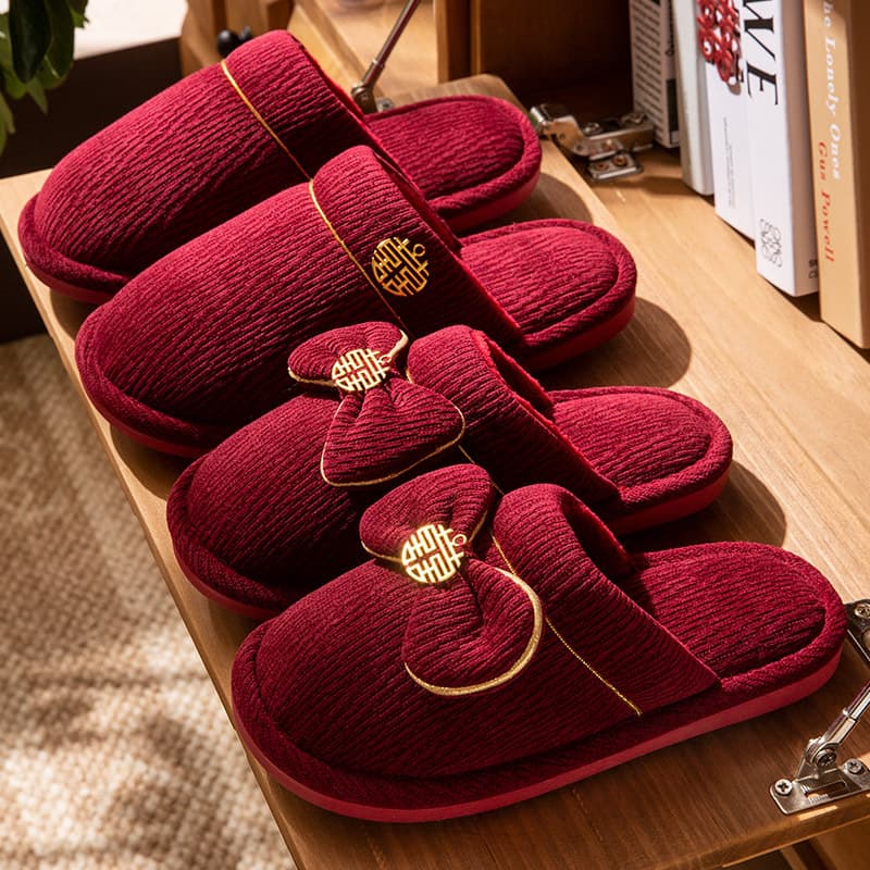 A pair of festive red wedding slippers for winter, ideal for bride and groom as dowry, couple's wedding or high-end home cotton slippers for women.