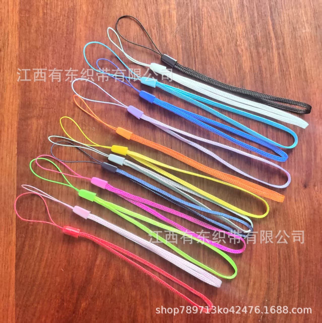 Wholesale colored bulk mobile phone lanyards, fan lanyards, short phone straps, camera lanyards, and pinecone cords.