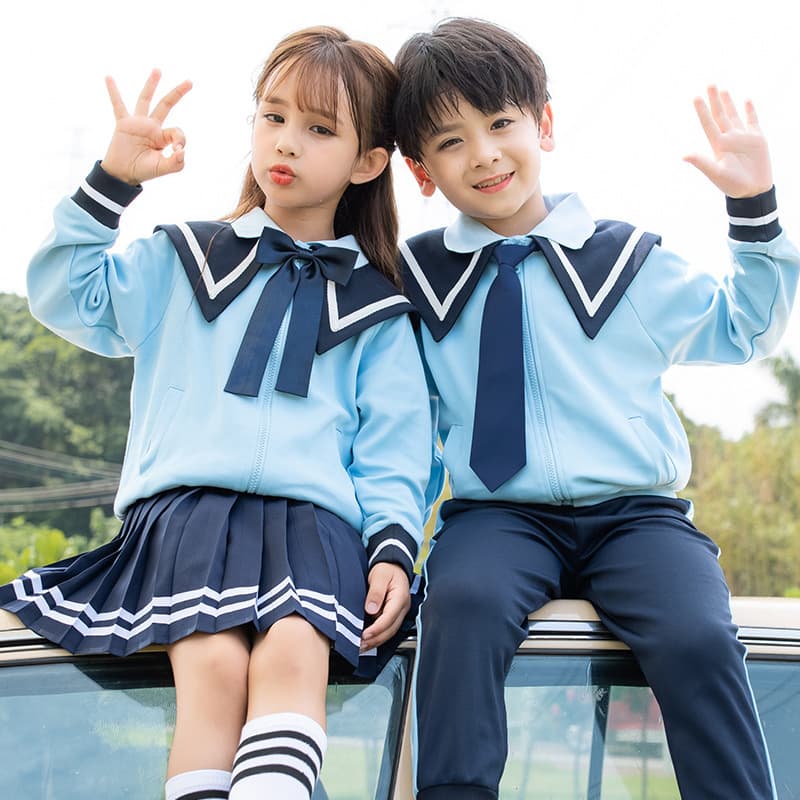 Four-piece kindergarten teacher uniform with navy collar for first-grade class and academic-style suits for students.