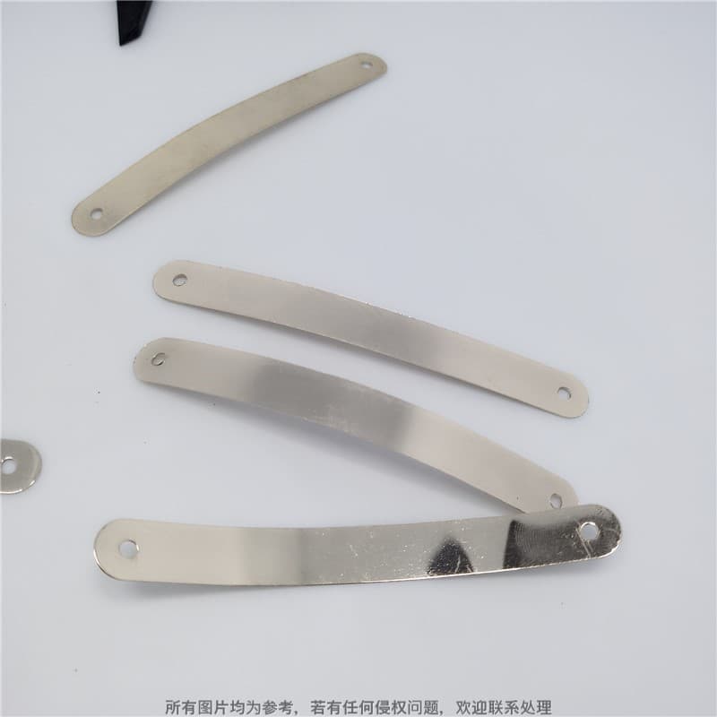 Gold-plated decorative trim for shoe heel hardware; flexible metal trim with two holes for nailing.