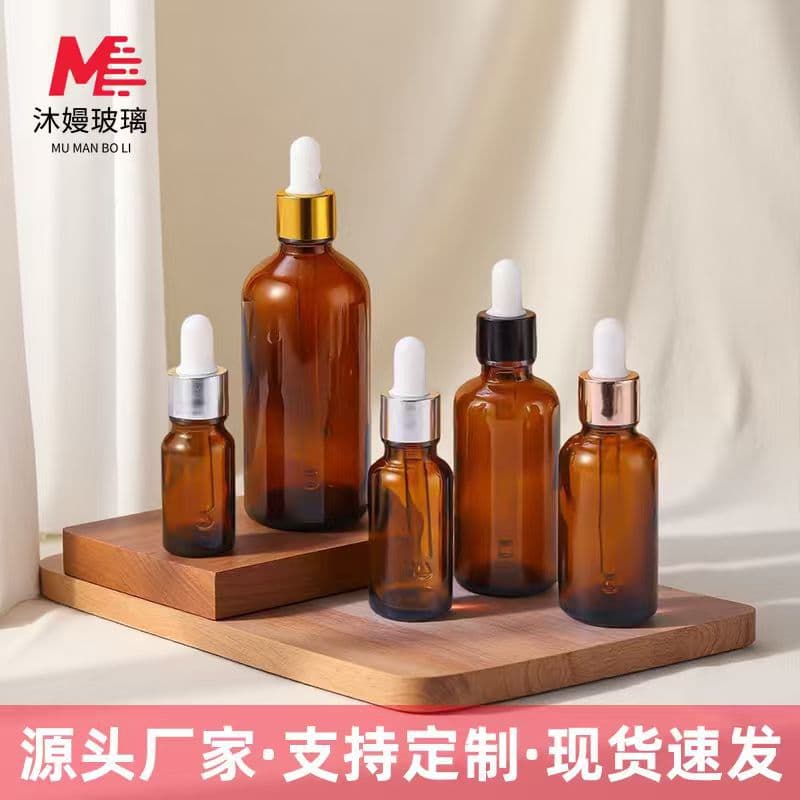 Amber glass essential oil bottles, brown light-protected rubber dropper bottles, cosmetic dispensing containers, bulk pricing available