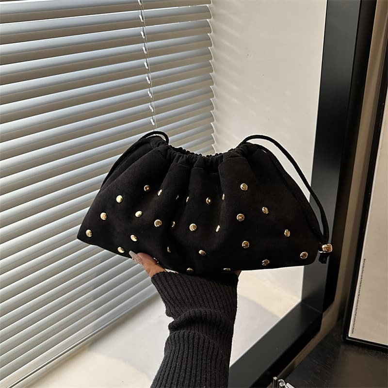 Simple and versatile portable bucket bag shoulder tote bag 2026 autumn and winter fashion rivets hollow armpit women's bag